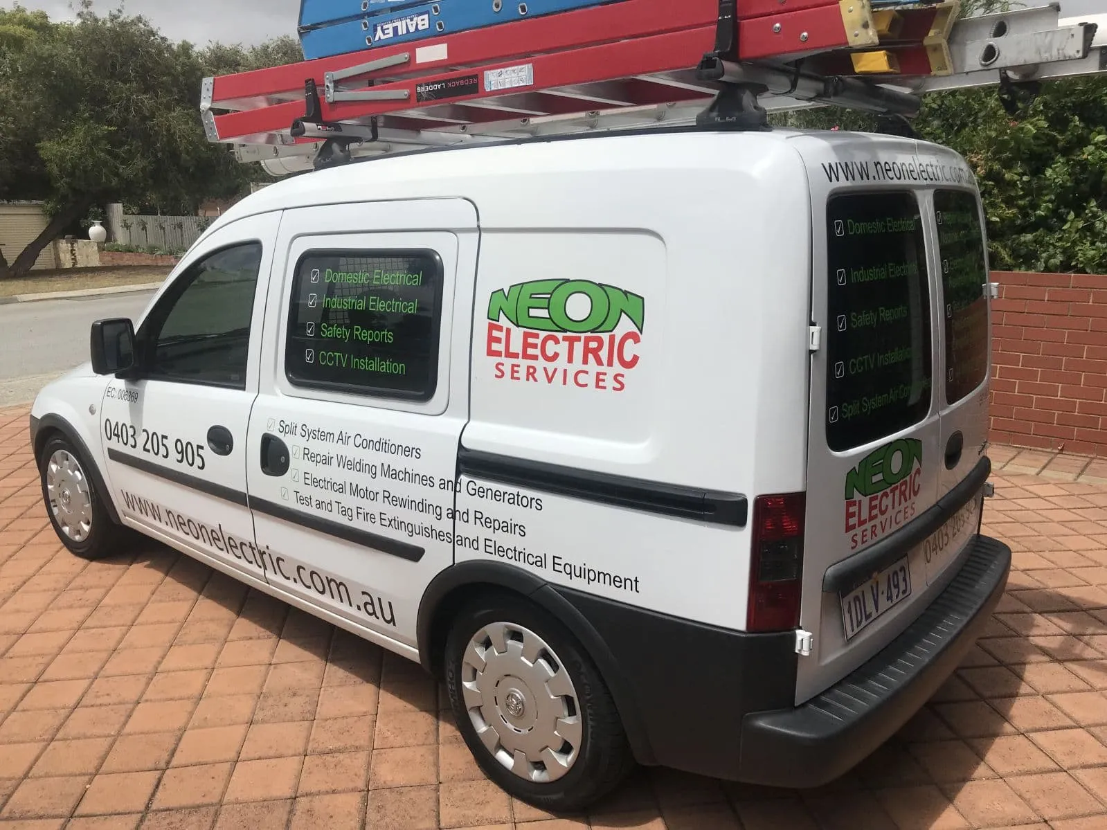Neon Electric Services van with ladders on the roof rack